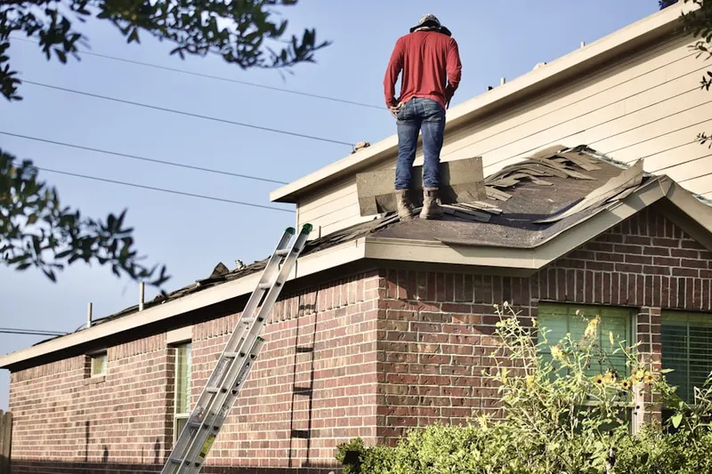 Professional roofer working on a residential roof in Rising Sun